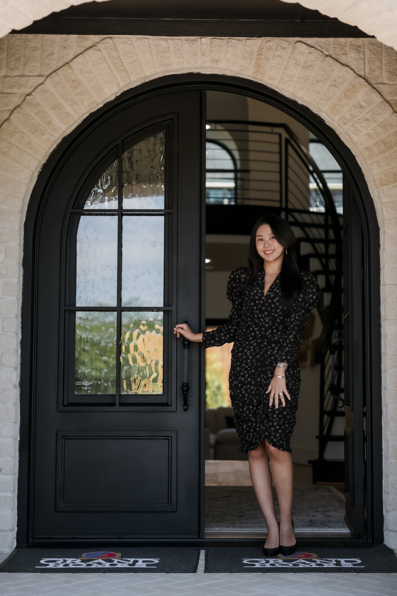 Kenzie Kim at the entrance of a luxury Austin home