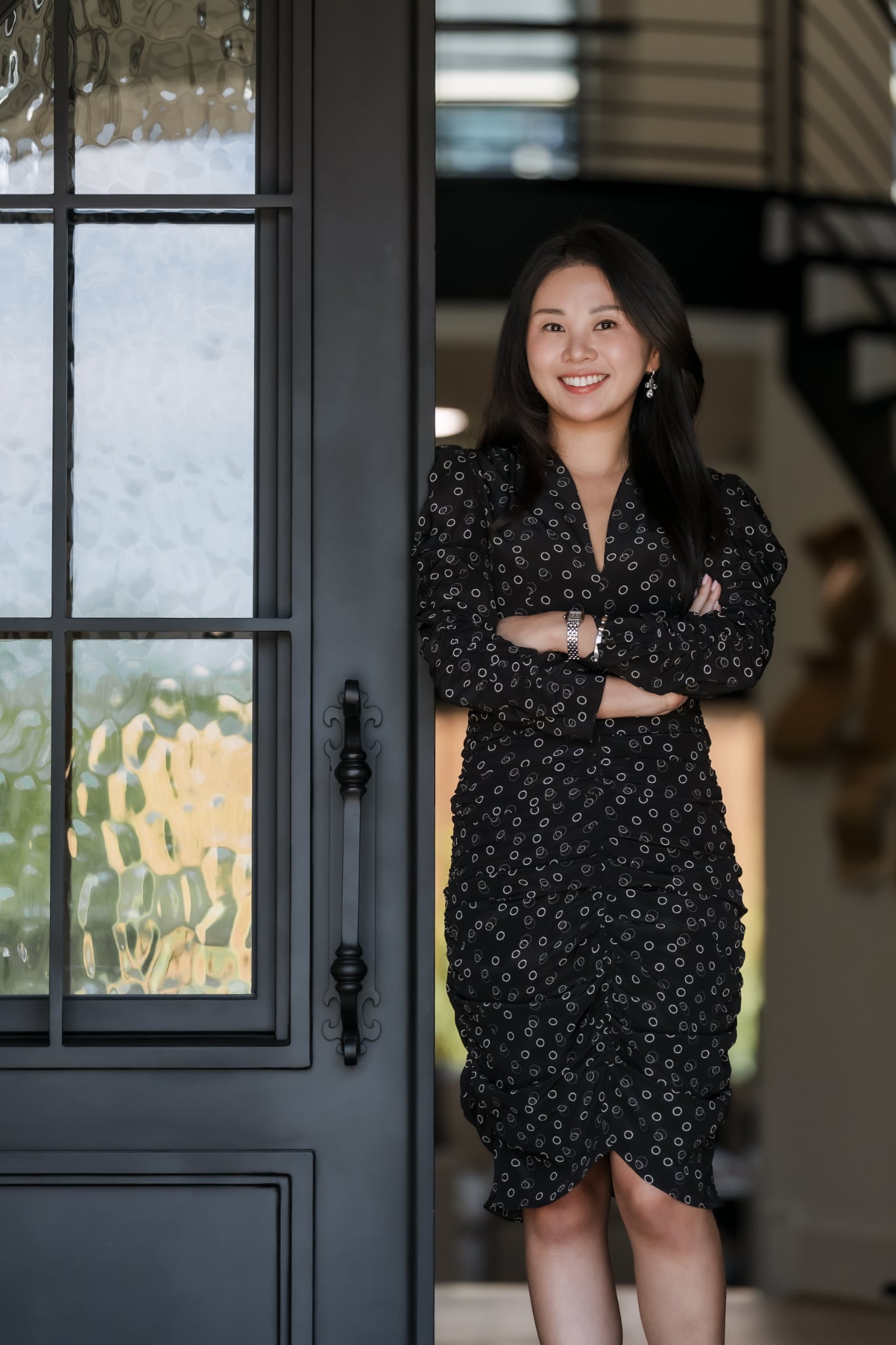 Kenzie Kim at the door of a luxury Austin home